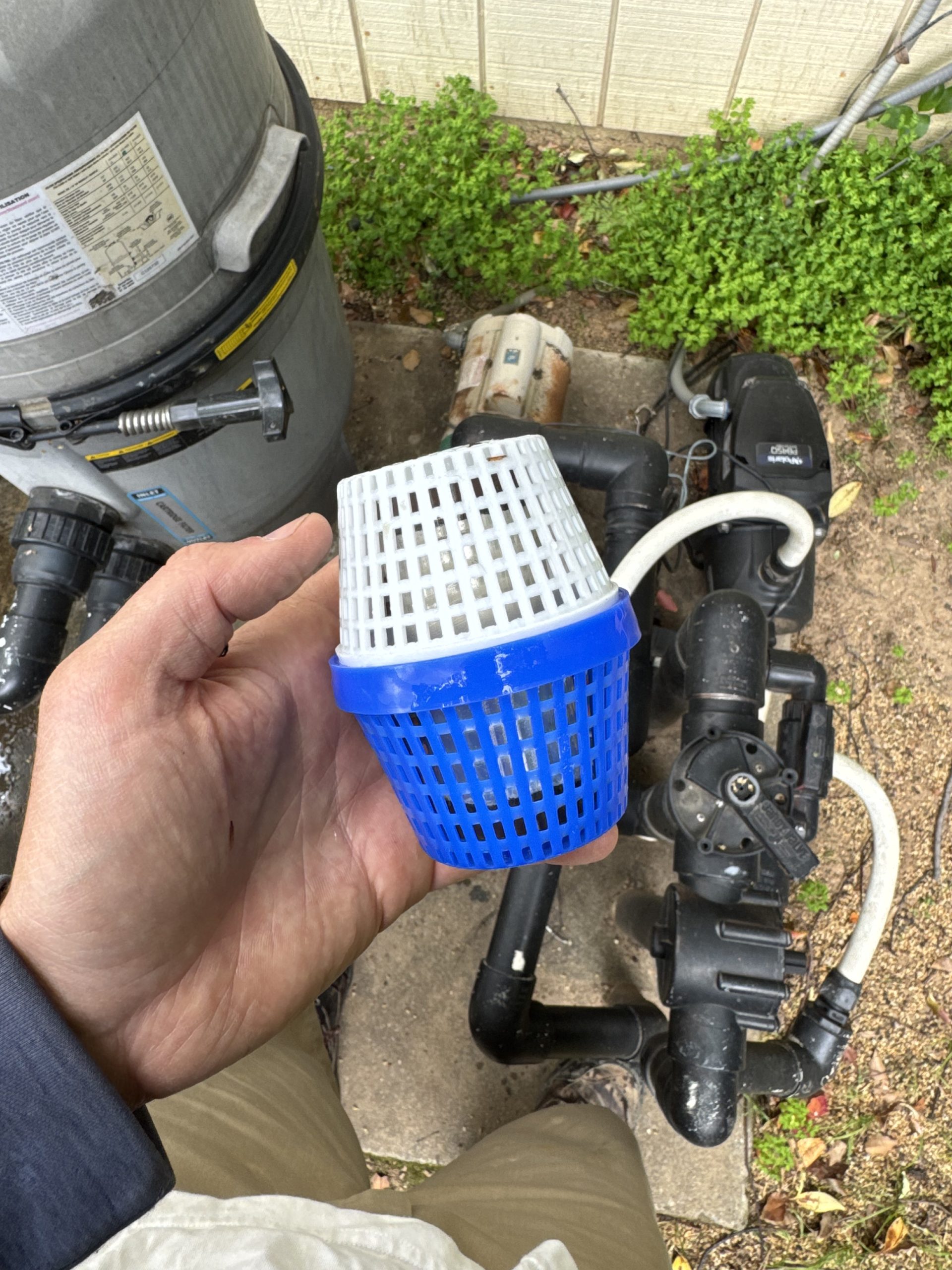 Cleaning pool pump basket in Folsom CA to remove leaves and debris for better flow